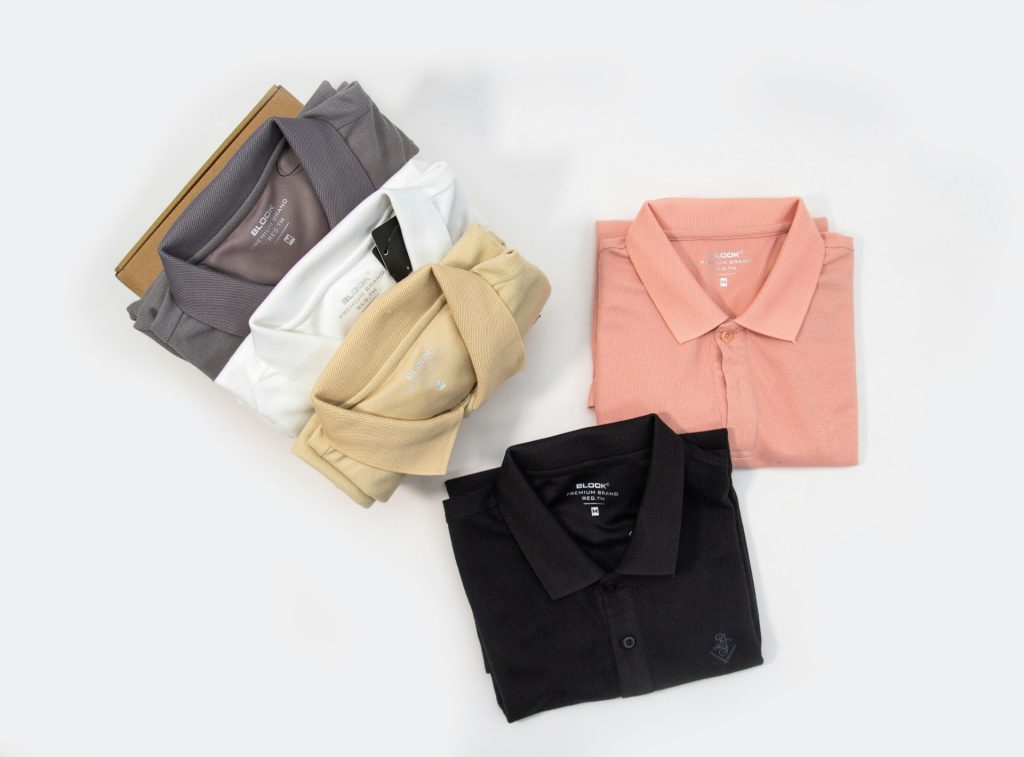 four different colors of polo shirts on a white background
